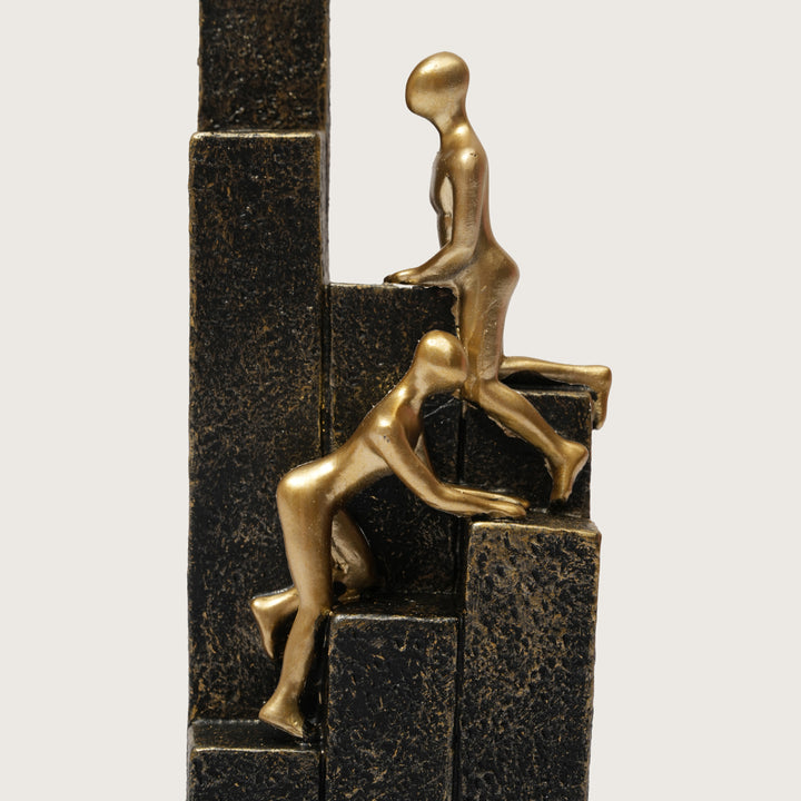 Motivational Gold & Black Figurines on Textured Steps