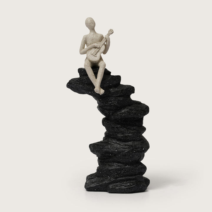 Abstract Guitarist Figurine on Stacked Black Rock Sculpture