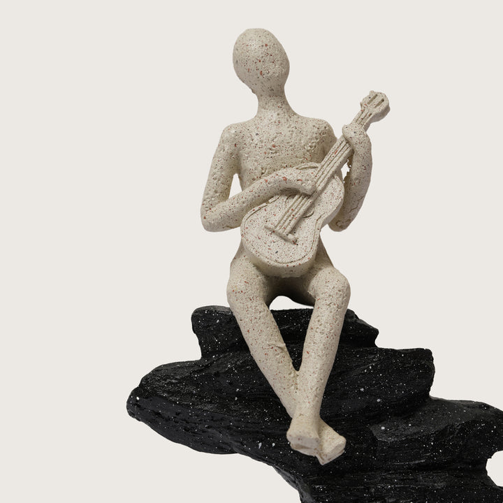 Abstract Guitarist Figurine on Stacked Black Rock Sculpture