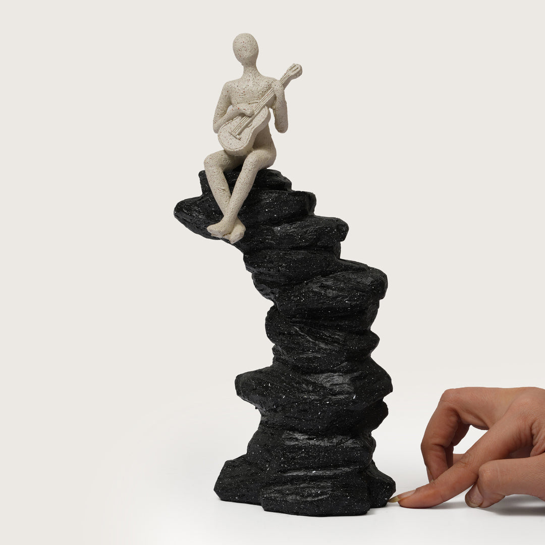 Abstract Guitarist Figurine on Stacked Black Rock Sculpture
