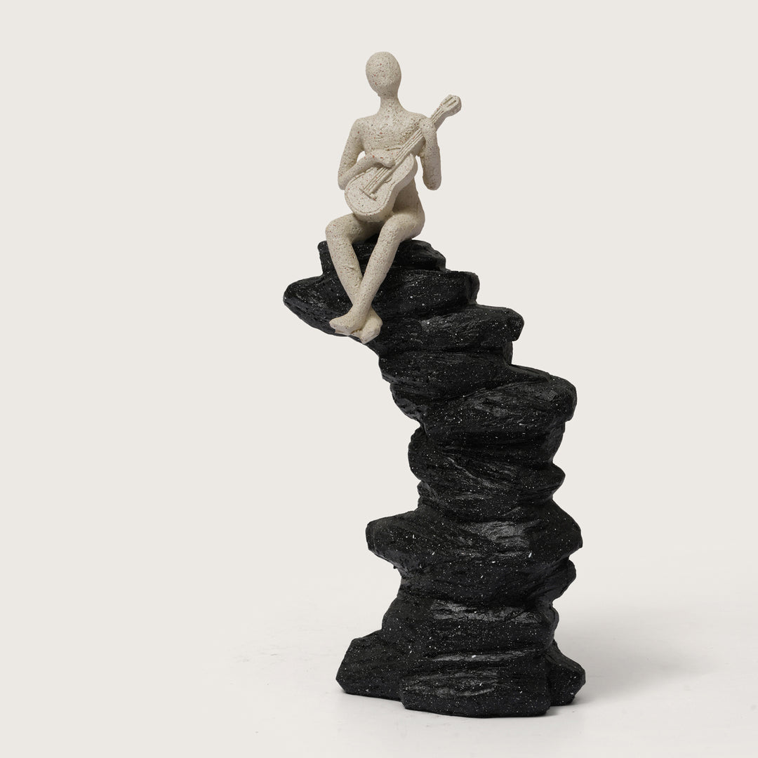 Abstract Guitarist Figurine on Stacked Black Rock Sculpture
