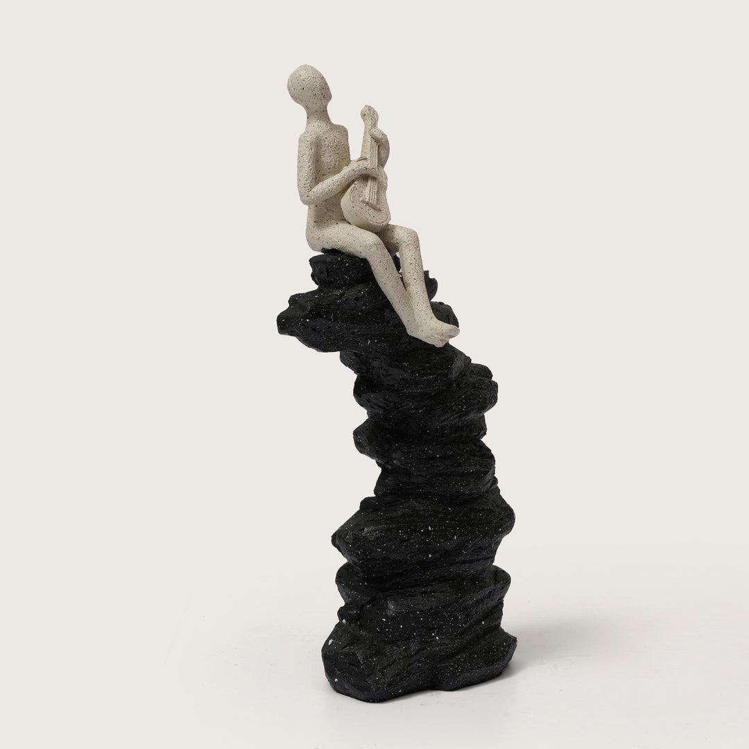 Abstract Guitarist Figurine on Stacked Black Rock Sculpture