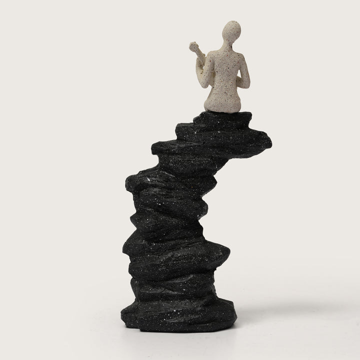 Abstract Guitarist Figurine on Stacked Black Rock Sculpture