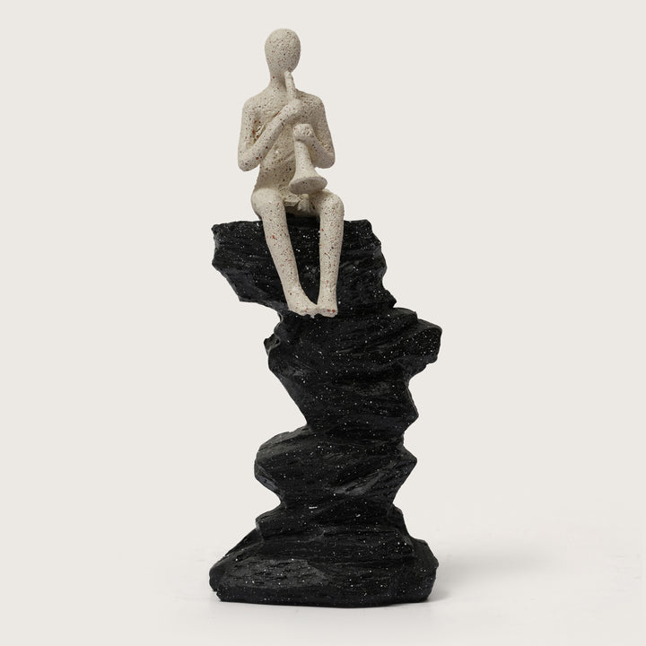 Abstract Horn Player Figurine on Stacked Black Rock Sculpture