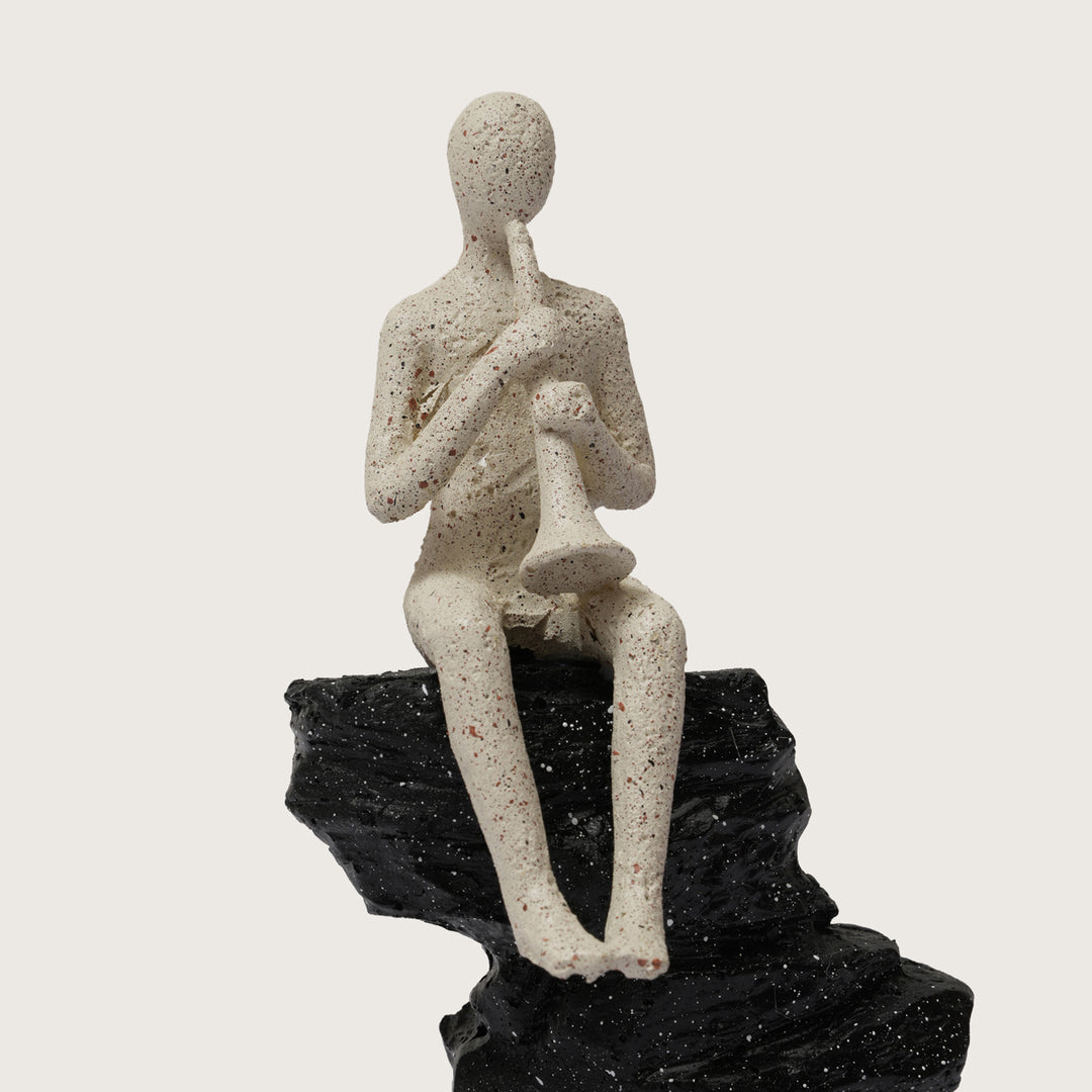 Abstract Horn Player Figurine on Stacked Black Rock Sculpture