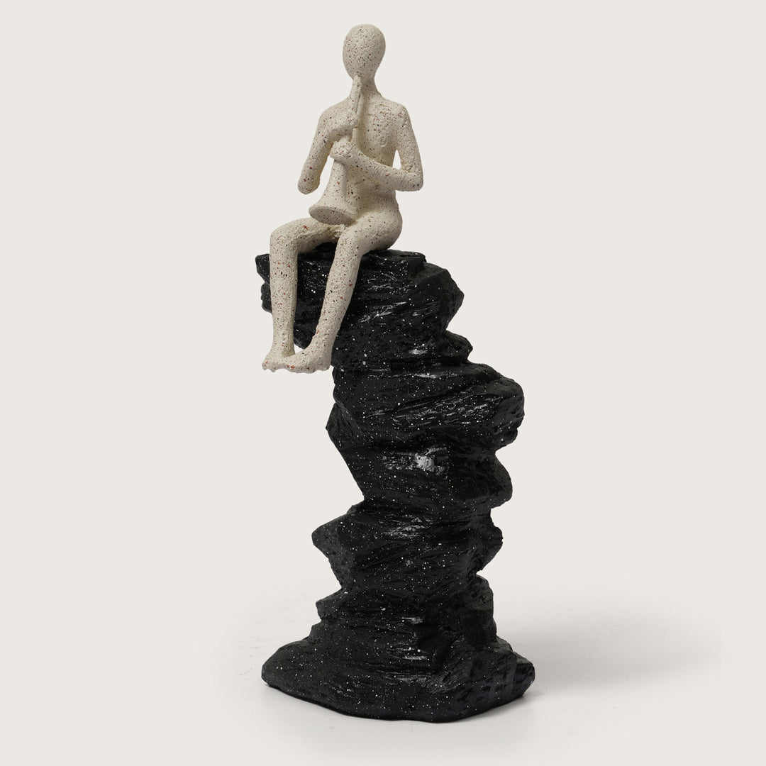 Abstract Horn Player Figurine on Stacked Black Rock Sculpture