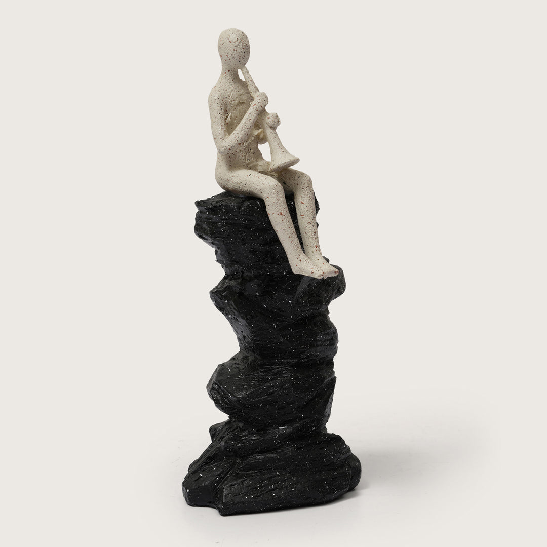 Abstract Horn Player Figurine on Stacked Black Rock Sculpture