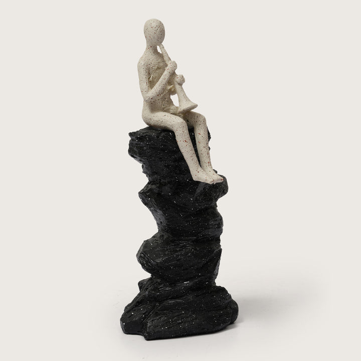 Abstract Horn Player Figurine on Stacked Black Rock Sculpture