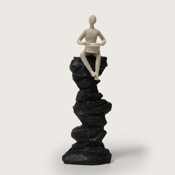 Abstract Drummer Figure on Black Stone Pillar Statue