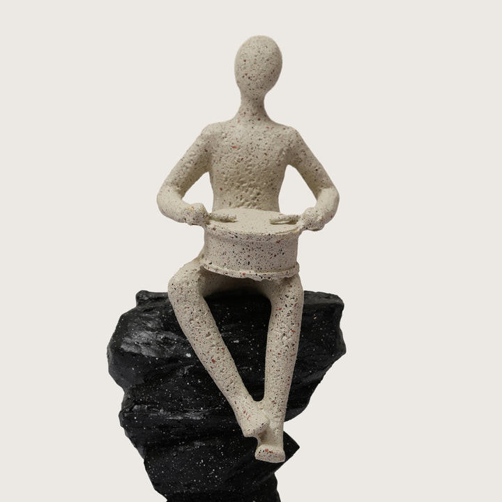 Abstract Drummer Figure on Black Stone Pillar Statue