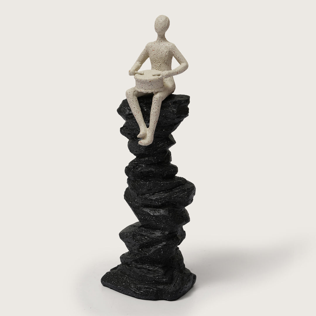 Abstract Drummer Figure on Black Stone Pillar Statue