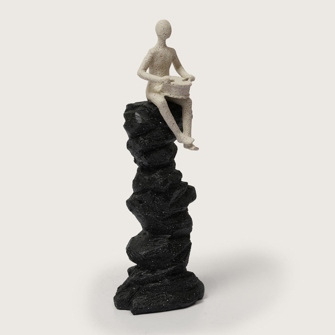Abstract Drummer Figure on Black Stone Pillar Statue