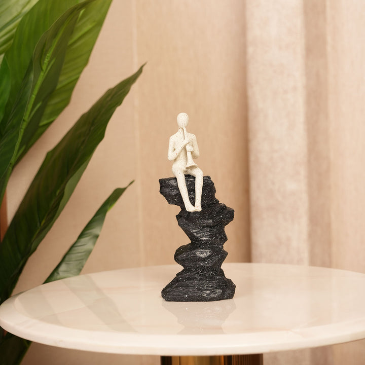 Abstract Horn Player Figurine on Stacked Black Rock Sculpture