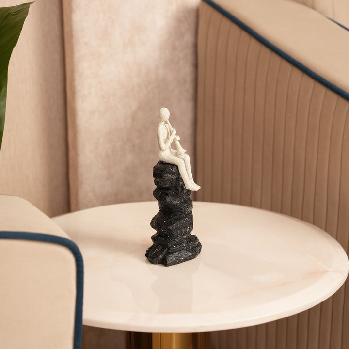 Abstract Horn Player Figurine on Stacked Black Rock Sculpture