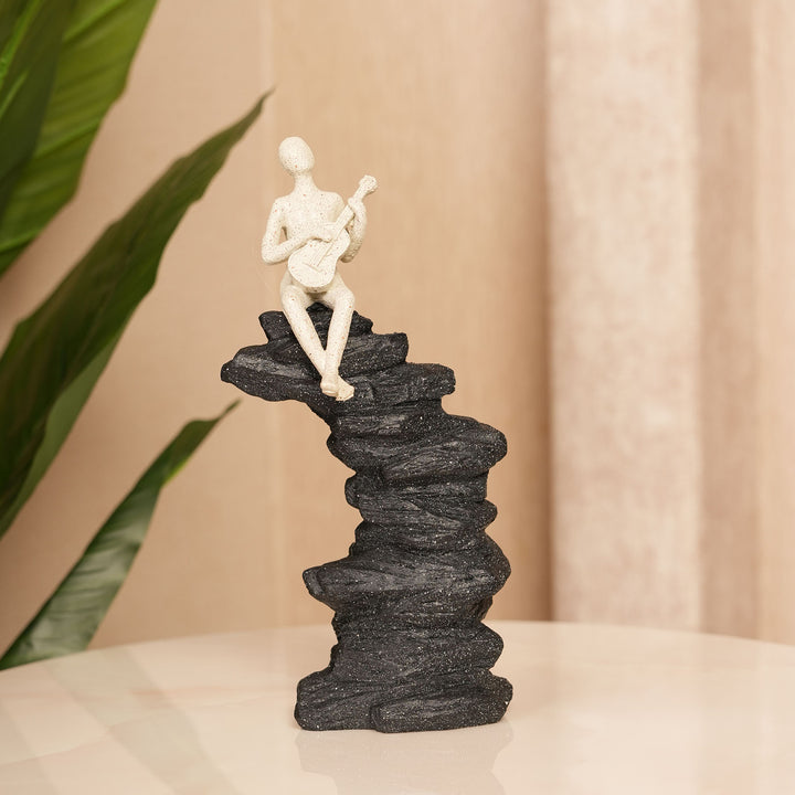 Abstract Guitarist Figurine on Stacked Black Rock Sculpture