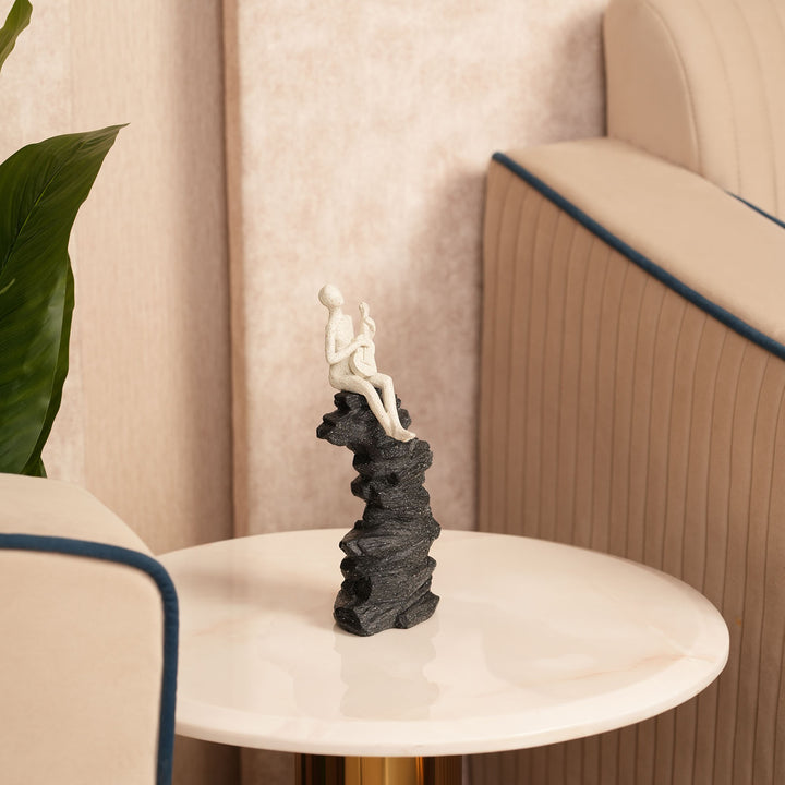 Abstract Guitarist Figurine on Stacked Black Rock Sculpture