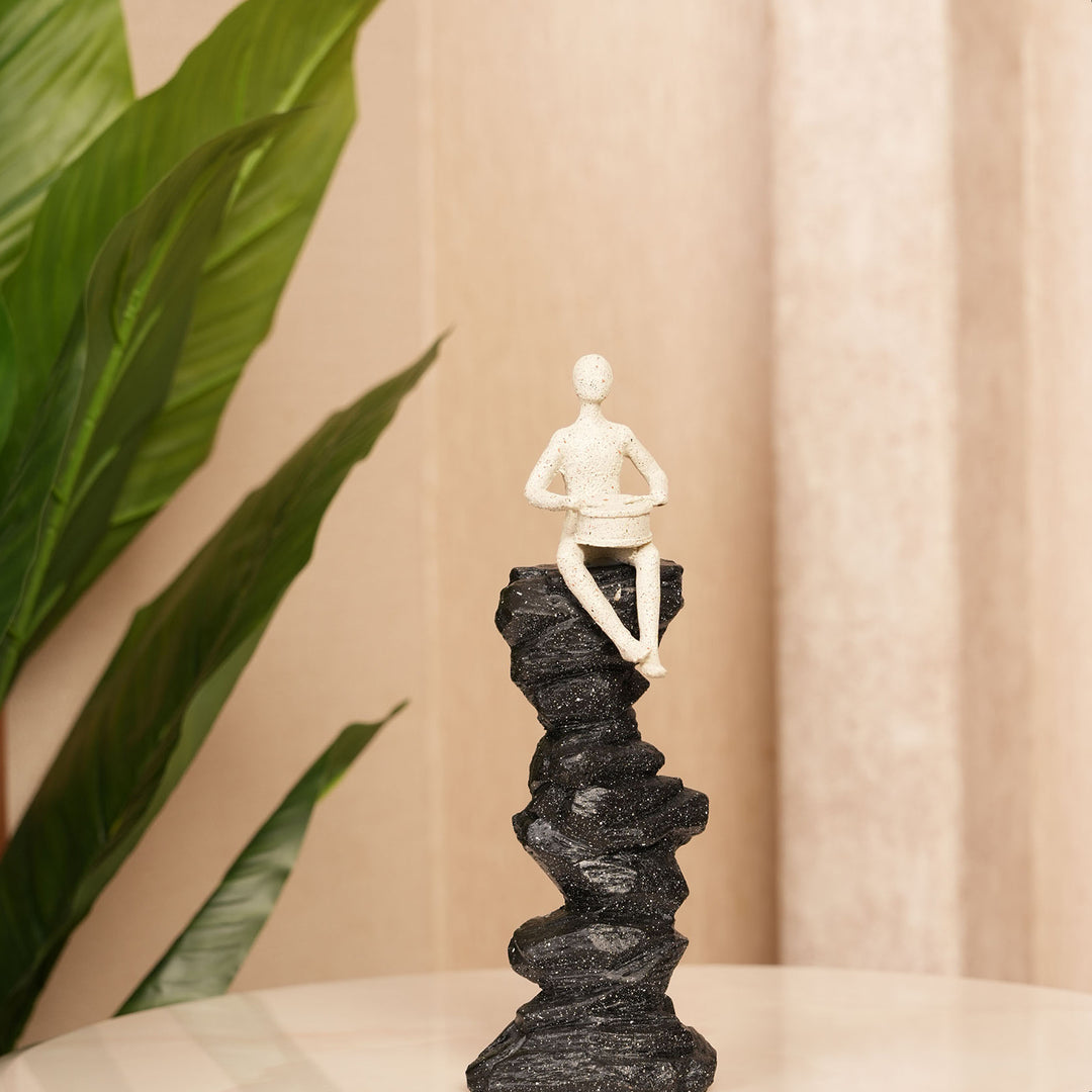 Abstract Drummer Figure on Black Stone Pillar Statue