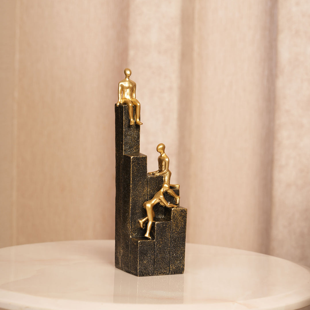 Motivational Gold & Black Figurines on Textured Steps