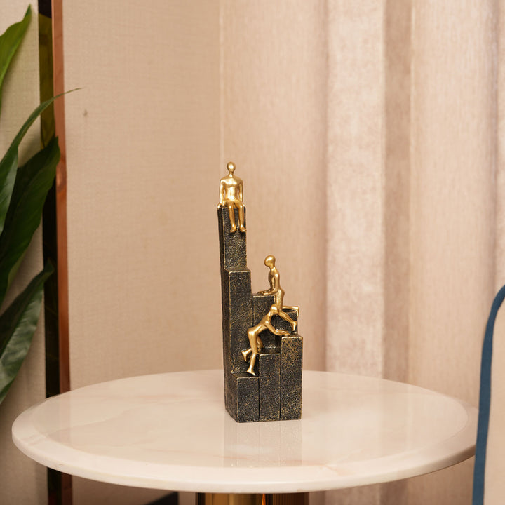 Motivational Gold & Black Figurines on Textured Steps