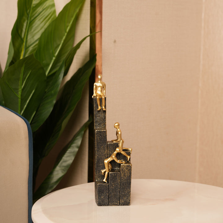 Motivational Gold & Black Figurines on Textured Steps